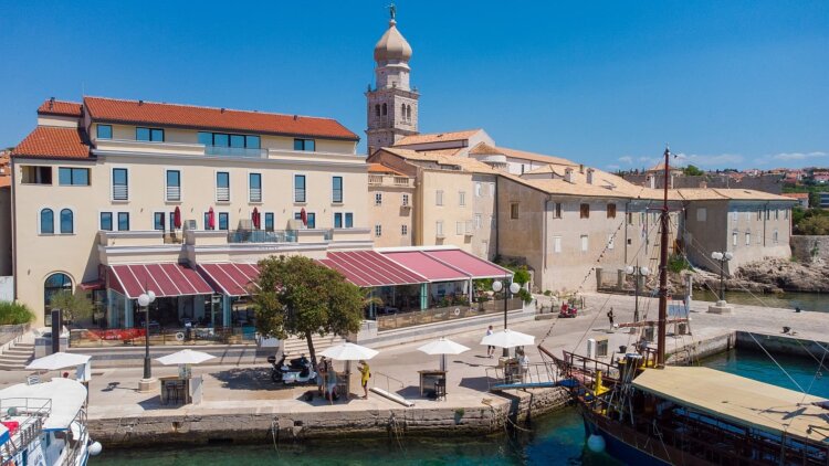  Boutique Hotel Marina on Krk island, overlooking the waterfront with a moored boat in the background
